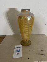 Full view of the iridescent art glass vase showing pulled feather pattern and shape.