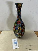 Full view of the tall colorful ceramic vase with mosaic panels