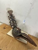 Front-left angled view showing overall form, beak and geometric patterns.