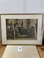 Framed collotype print depicting Afro-Cuban spiritual scene featuring a rooster and natural elements, signed and titled 'Elegua en el Monte'.