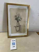 Framed vintage floral still life sketch on a small wooden table