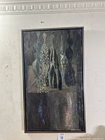 Full frontal view of the framed oil painting hung on a white wall with numbered sticker visible below.