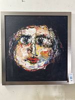 Frontal view of the framed mixed media abstract portrait painting showing whole artwork.