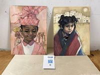 Two watercolor portraits side by side showing Indigenous children, one boy with pink headwrap, one girl with shawl and village background