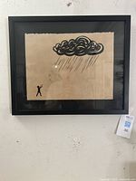 Framed serigraph artwork titled 'Return Fire' by David B. Cuzick hung on wall.