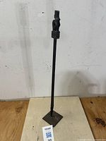 Full view of the 21.5" tall carved wooden amulet standing on a base.