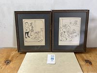 Two framed single-panel comic strips by Virgil Partch showing both cartoons together on a table.