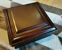 Top view of the wooden jewelry/watch box showing the stepped edge design on the lid and the polished finish.