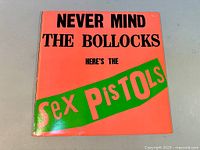 Front cover of the vinyl LP showing the bright orange background with bold black and green lettering.