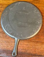 Bottom view of the cast iron skillet with markings '5', 'Made in France', and 'Cousances' embossed on the base.