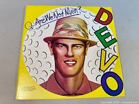 Front cover of the DEVO vinyl album showing the graphic illustration and band/album titles.