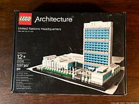 Front view of the LEGO Architecture 21018 United Nations Headquarters box showing the model image, set name, piece count, and brand.