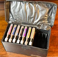 Carry case two-thirds full of NES games with visible tape repairs on inner lid