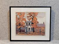 Framed print showing the street scene with houses and fall trees.