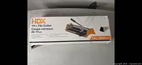 Box of HDX 14-inch tile cutter showing brand, product name and size in English and French.