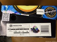 Box label showing Heelys brand, style Force, size 13C youth, black color with product image and instructions.