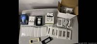 Lot of white and black wall plate covers, electric sockets, arranged front on a table