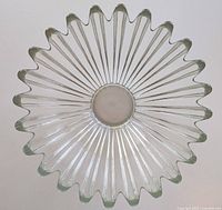 Top-down view of the large clear glass bowl showing its starburst scalloped edge and radiating ribbed design.
