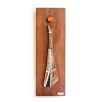 Full view of ceramic tile mounted on rectangular wooden board, showing overall design and colors.