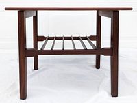 Front view of side table showing four legs and lower slatted wooden shelf.