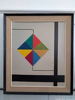 Full front view of the framed abstract painting showing the geometric colored diamond and black lines on a beige background.