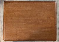 Top view showing smooth teak wood surface with natural wood grain.