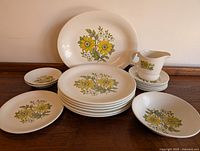 Full set of Wood & Sons Greenwood ironstone including plates, saucers, and creamer on wooden surface.