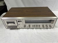 Front view of Fisher audio component system showing wood grain top and silver front panel with cassette deck and control buttons