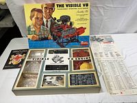 Full opened box with engine parts, manual, and instruction sheet visible