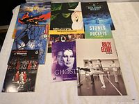 Photo shows seven different theatre play schedules arranged on a white surface. Covers include images from Wicked, Bolshoi Ballet, Stones in His Pockets, Lady Macbeth of Mtsenska, Ghost, Billy Elliot.