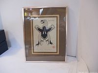 Framed artwork showing the full art print in silver metal frame with brown and cream mats.