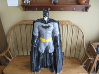 Front view of 34 inch Batman figure in standing position showing detailed chest emblem, yellow utility belt, and black cape closed.