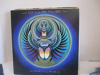 Front album cover with distinct circular scarab artwork and 'Captured' title