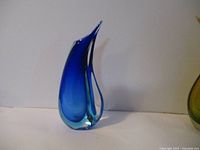 Front view of the blue Murano style vase showing curved teardrop shape and color gradient from deep blue to clear glass base.