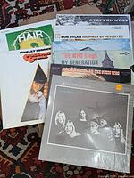 Assorted vinyl LP album covers fanned out on floor