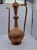 Full view of the large copper pitcher showing shape, handle, and spout