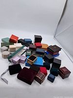 Overview of all jewellery boxes and cases in various colors, materials, and sizes arranged together showing the lot variety.