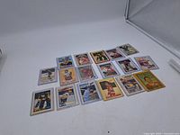 16 sports cards laid out on white background, front view