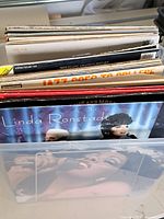 Side view of the lot showing various vintage vinyl record album covers including Wolfgang Amadeus Mozart and Linda Ronstadt.