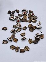 Scattered vintage Red Cross sterling silver enamel pins front and back view on white background