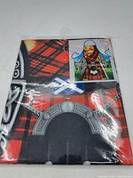 Plastic packaged novelty apron showing detailed print of male in Scottish kilt attire with shield and castle background.