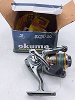 Okuma ROX-20 fly fishing reel with green line and original box shown, box with some wear.
