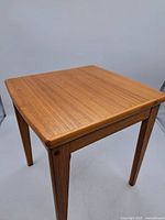 Full view of square teakwood side table showing top and legs