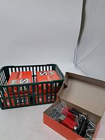 Overview of two original Salomon ski binding boxes placed inside a plastic basket, showing the red and white Salomon packaging.