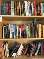 Books arranged on shelves showing a variety of fiction and non-fiction titles including birding and addiction themes