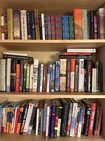 Bookshelves with multiple books of varied genres including Harry Potter, fiction, non-fiction, travel, and food.