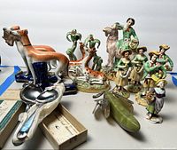 Overview of all ceramic figurines, jade banana, and Hennessy spoons