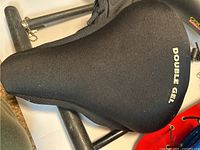 Black padded bike seat cover with 'DOUBLE GEL' text on top