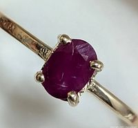 Close-up front view of ring head showing oval ruby