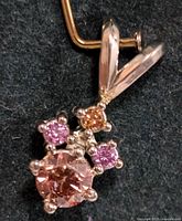 Front view close-up of pendant showing arrangement of colored diamonds